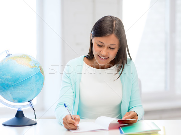 teacher with globe and notepad at school Stock photo © dolgachov