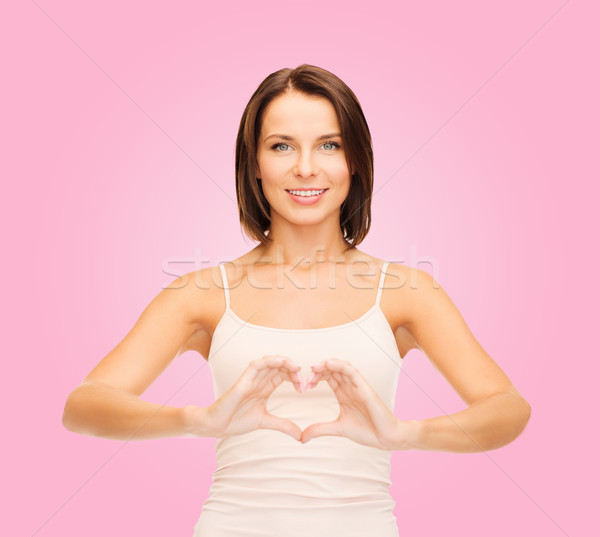 woman forming heart shape Stock photo © dolgachov