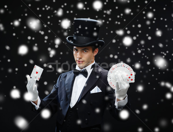 magician showing trick with playing cards Stock photo © dolgachov