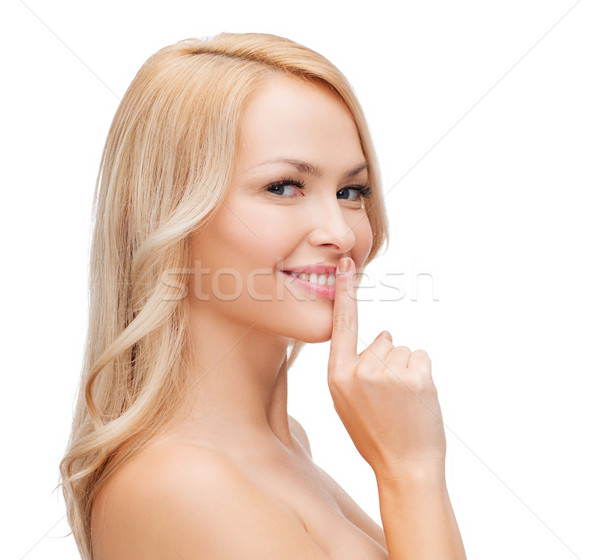Hermosa senalando dedo labios salud Foto stock © dolgachov