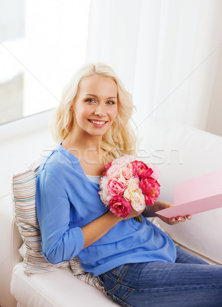 smiling woman with card and bouquet of flowers Stock photo © dolgachov