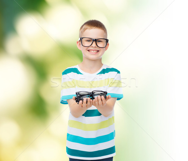 smiling boy in eyeglasses holding spectacles Stock photo © dolgachov