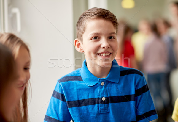 group of smiling school kids in corridor Stock photo © dolgachov
