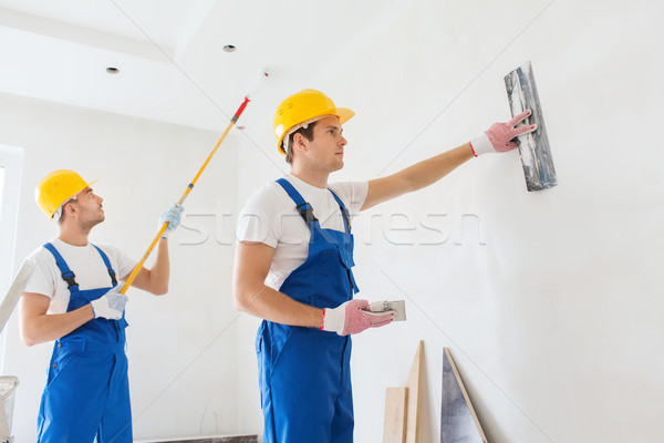 group of builders with tools indoors Stock photo © dolgachov