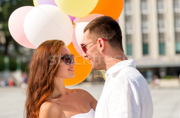 smiling couple in city Stock photo © dolgachov