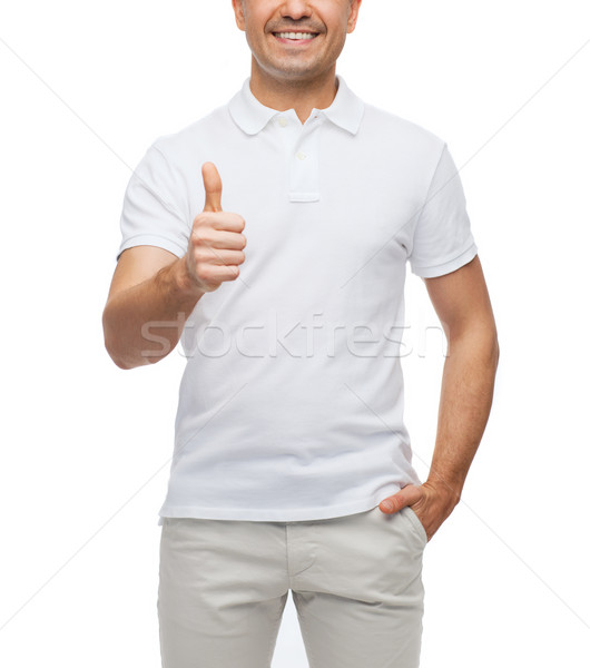 smiling man showing thumbs up Stock photo © dolgachov