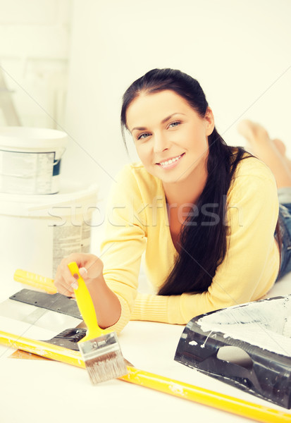 woman with paintbrush and renovating tools Stock photo © dolgachov