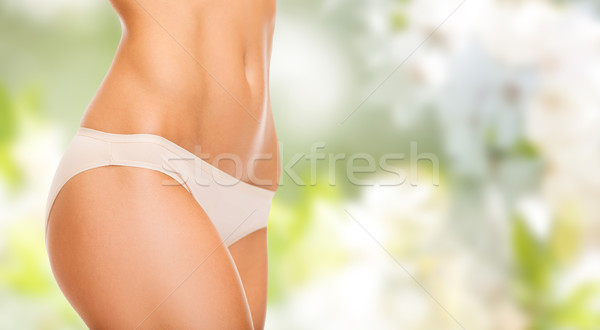 close up of slim woman tummy and hips in underwear Stock photo © dolgachov