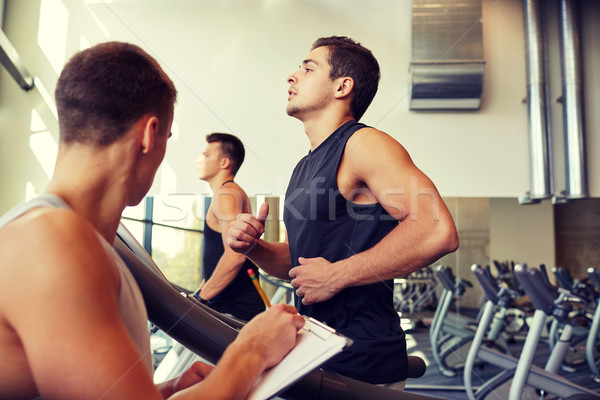 men exercising on treadmill in gym Stock photo © dolgachov