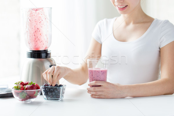 close up of woman with blender and milk shake Stock photo © dolgachov