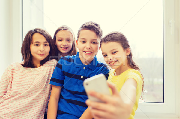 group of school kids taking selfie with smartphone Stock photo © dolgachov