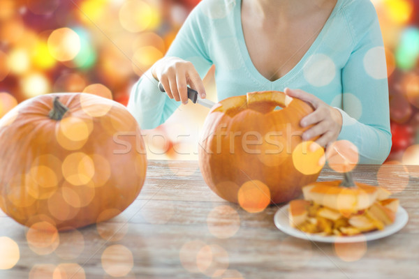 close up of woman carving pumpkins for halloween Stock photo © dolgachov