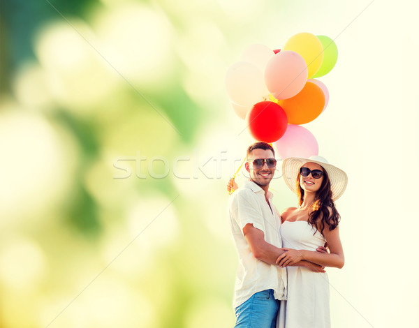 smiling couple with air balloons outdoors Stock photo © dolgachov