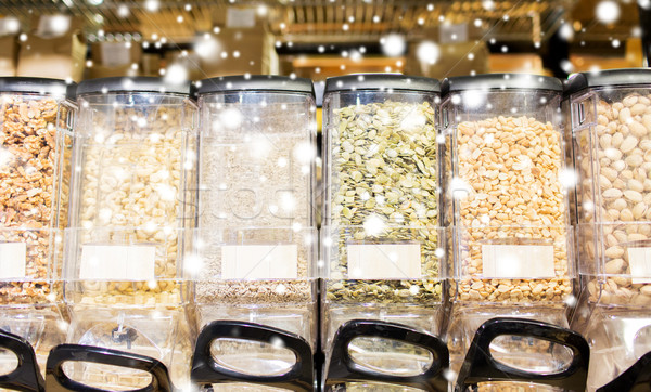 row of jars with nuts and seeds at grocery store Stock photo © dolgachov