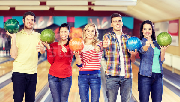happy friends in bowling club Stock photo © dolgachov