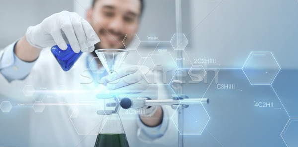 close up of scientist with test tubes and funnel Stock photo © dolgachov