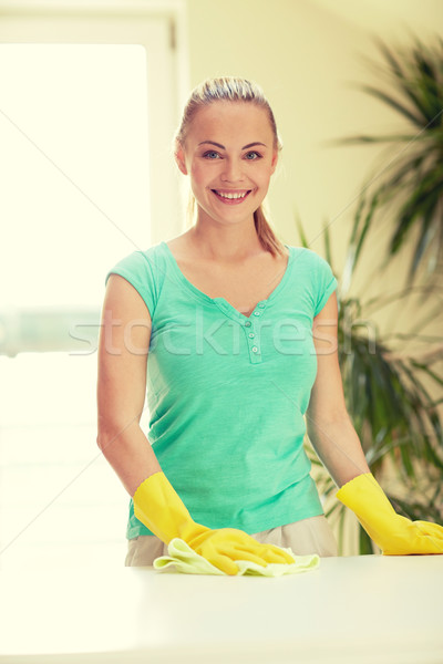 happy woman cleaning table at home kitchen Stock photo © dolgachov