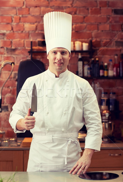 happy male chef cook in kitchen with knife Stock photo © dolgachov