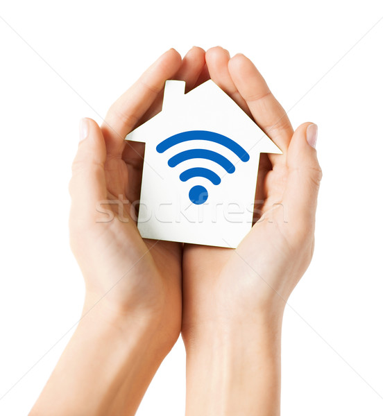 hands holding house with radio wave signal icon Stock photo © dolgachov