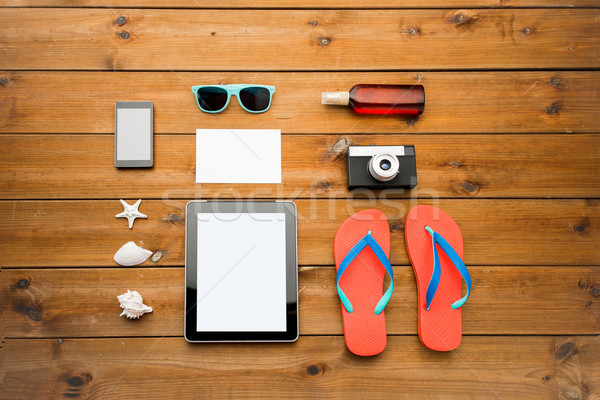 close up of tablet pc and travel stuff Stock photo © dolgachov