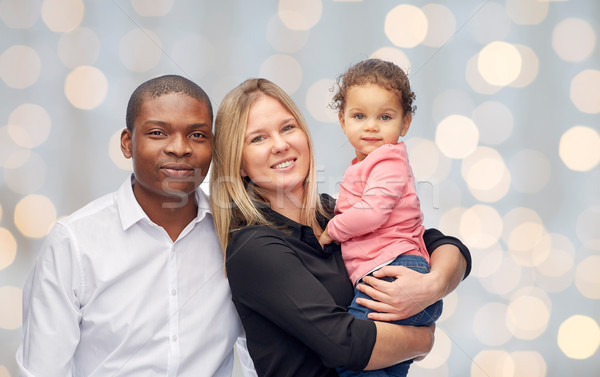 happy multiracial family with little child Stock photo © dolgachov
