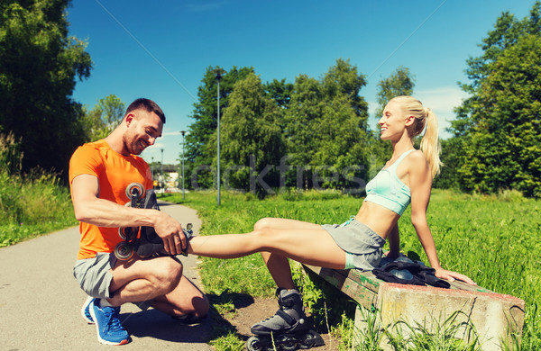 happy couple with rollerskates outdoors Stock photo © dolgachov