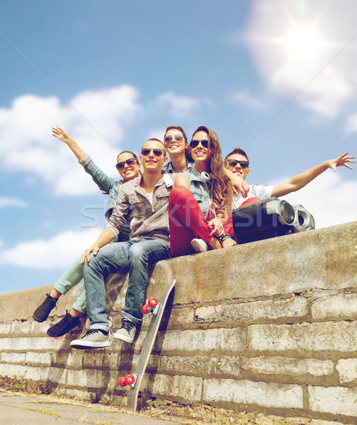 group of smiling teenagers hanging out Stock photo © dolgachov