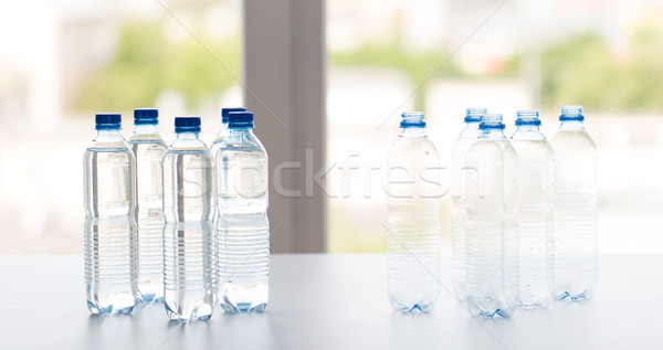 close up of bottles with drinking water on table Stock photo © dolgachov