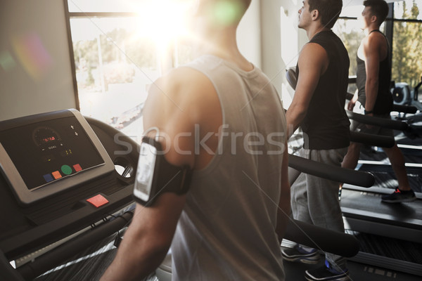 улыбаясь мужчин бегущая дорожка спортзал спорт Сток-фото © dolgachov