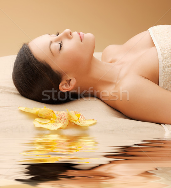 woman in spa salon lying on the massage desk Stock photo © dolgachov