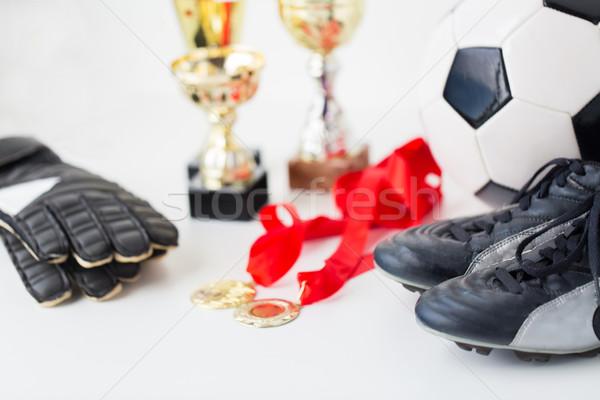 close up of football, boots, gloves, cup and medal Stock photo © dolgachov