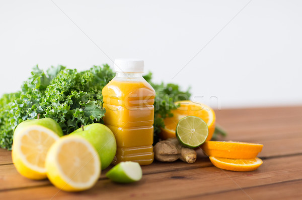 bottle with orange juice, fruits and vegetables Stock photo © dolgachov
