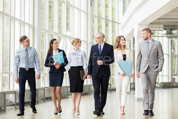 Stock photo: business people walking along office building