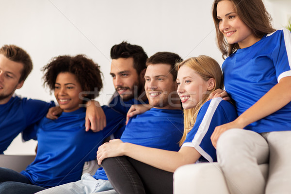 friends or football fans watching soccer at home Stock photo © dolgachov