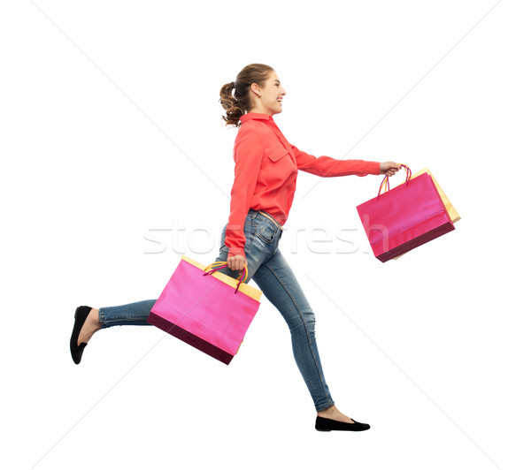 Glimlachend jonge vrouw lopen verkoop beweging Stockfoto © dolgachov