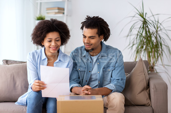 happy couple with parcel box and paper form home Stock photo © dolgachov