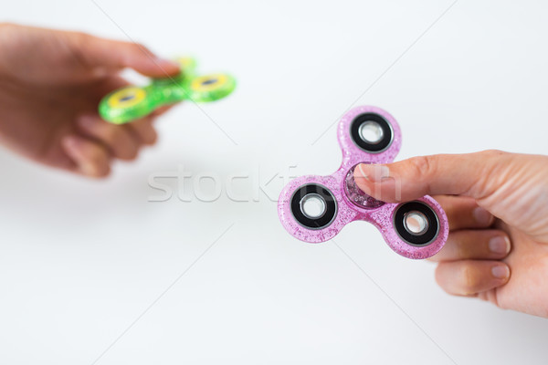 close up of two hands playing with fidget spinners Stock photo © dolgachov