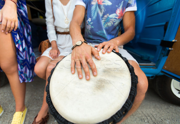 close up of hippie friends playing tom-tom drum Stock photo © dolgachov