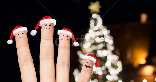 Közelkép ujjak mikulás sapkák karácsony ünnepek Stock fotó © dolgachov