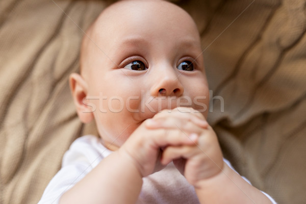 close up of sweet little baby boy lying on blanket Stock photo © dolgachov