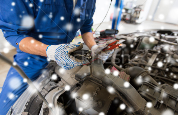 auto mechanic hands with cleats charging battery Stock photo © dolgachov
