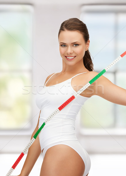 young beautiful woman with measure tape Stock photo © dolgachov