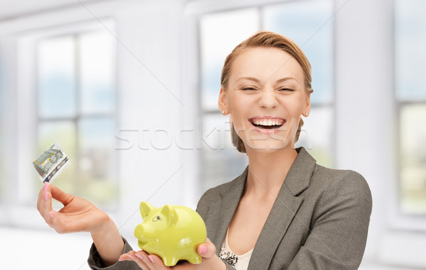 lovely woman with piggy bank and money Stock photo © dolgachov