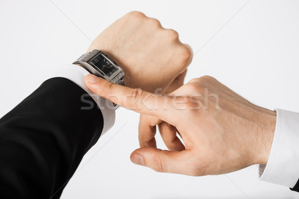 Stock photo: man looking at wristwatch