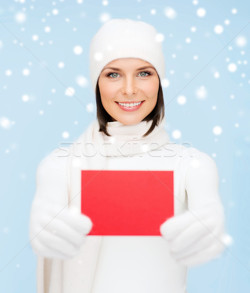 woman in winter clothes with blank red card Stock photo © dolgachov