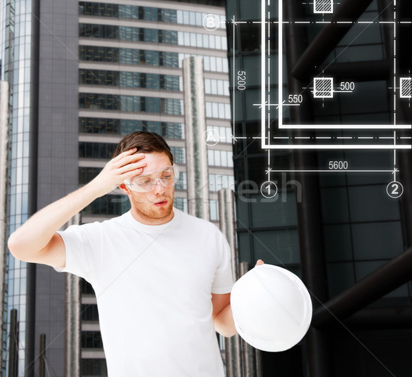 Masculina arquitecto gafas de seguridad toma casco Foto stock © dolgachov
