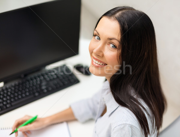 smiling businesswoman or student studying Stock photo © dolgachov