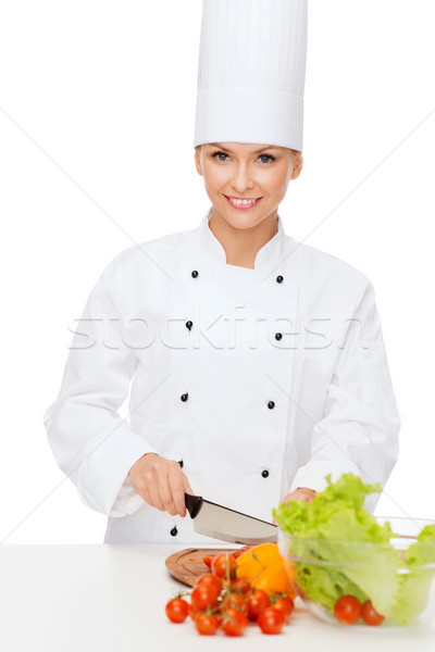 Stock photo: smiling female chef chopping vagetables