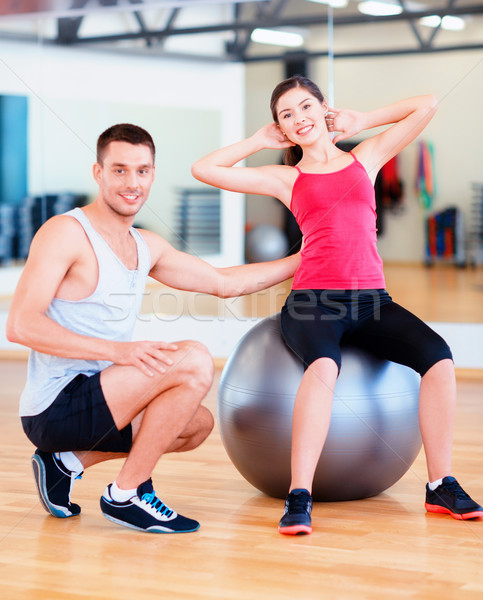 male trainer with woman doing crunches on the ball Stock photo © dolgachov
