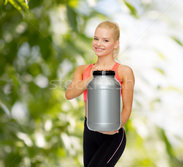 Sorridente mulher jarra proteína fitness Foto stock © dolgachov